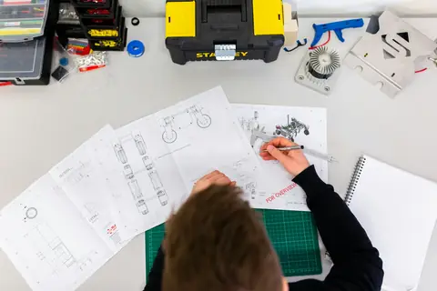 Architectural drawings and drafting tools laid out on a worktable