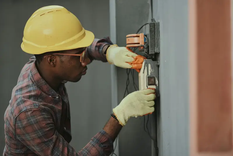 Licensed electrician wiring a residential electrical panel