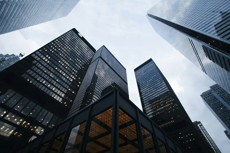 Glass office towers rising above a downtown commercial district