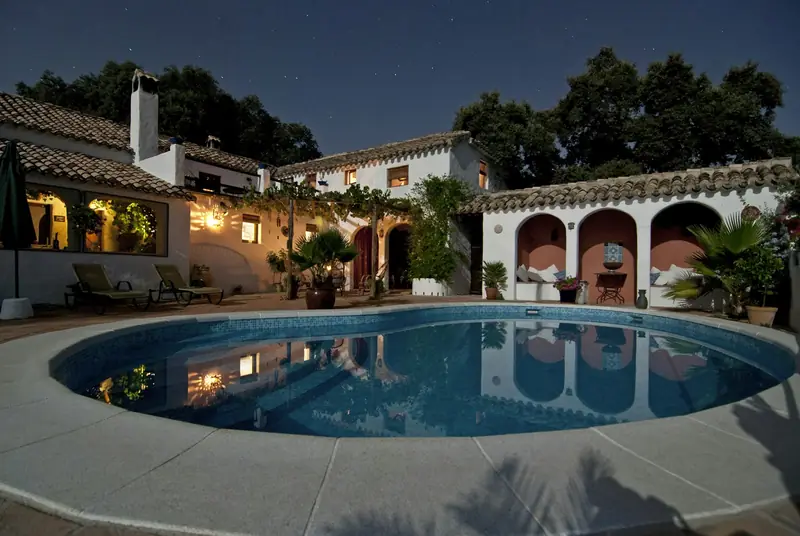 Luxury home with a pool and landscaped terrace at twilight