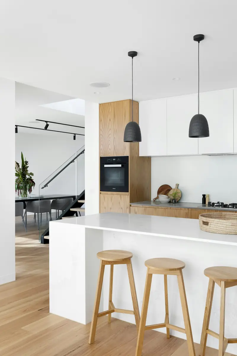 Minimal white interior with designer pendant lighting