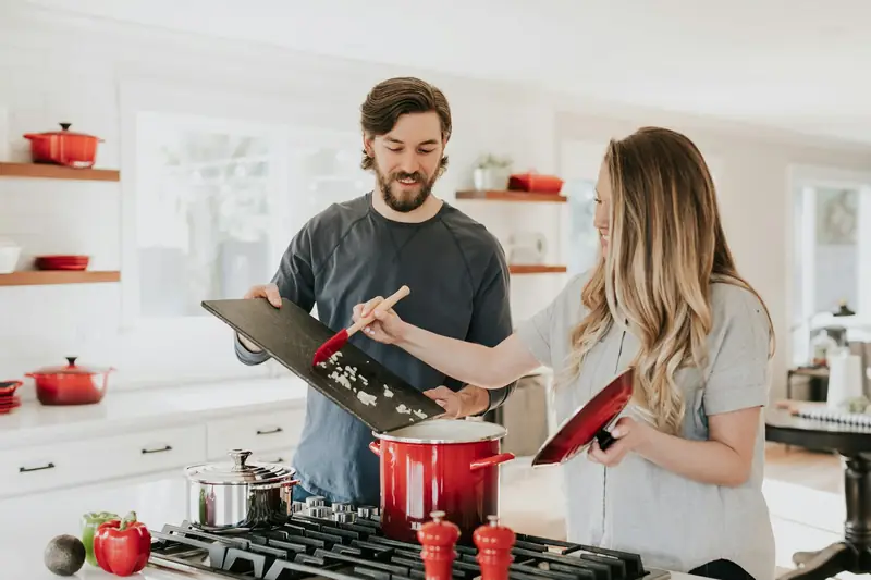 Homeowners cooking in their newly remodeled white kitchen