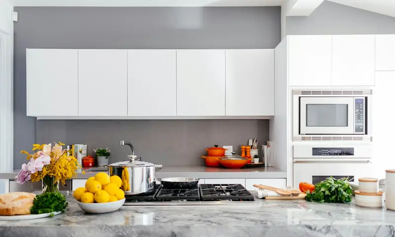 Bright white kitchen with quartz counters after a full remodel