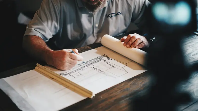 Project manager reviewing a bound set of construction documents
