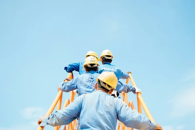 Construction crew in high-visibility vests reviewing a build on site